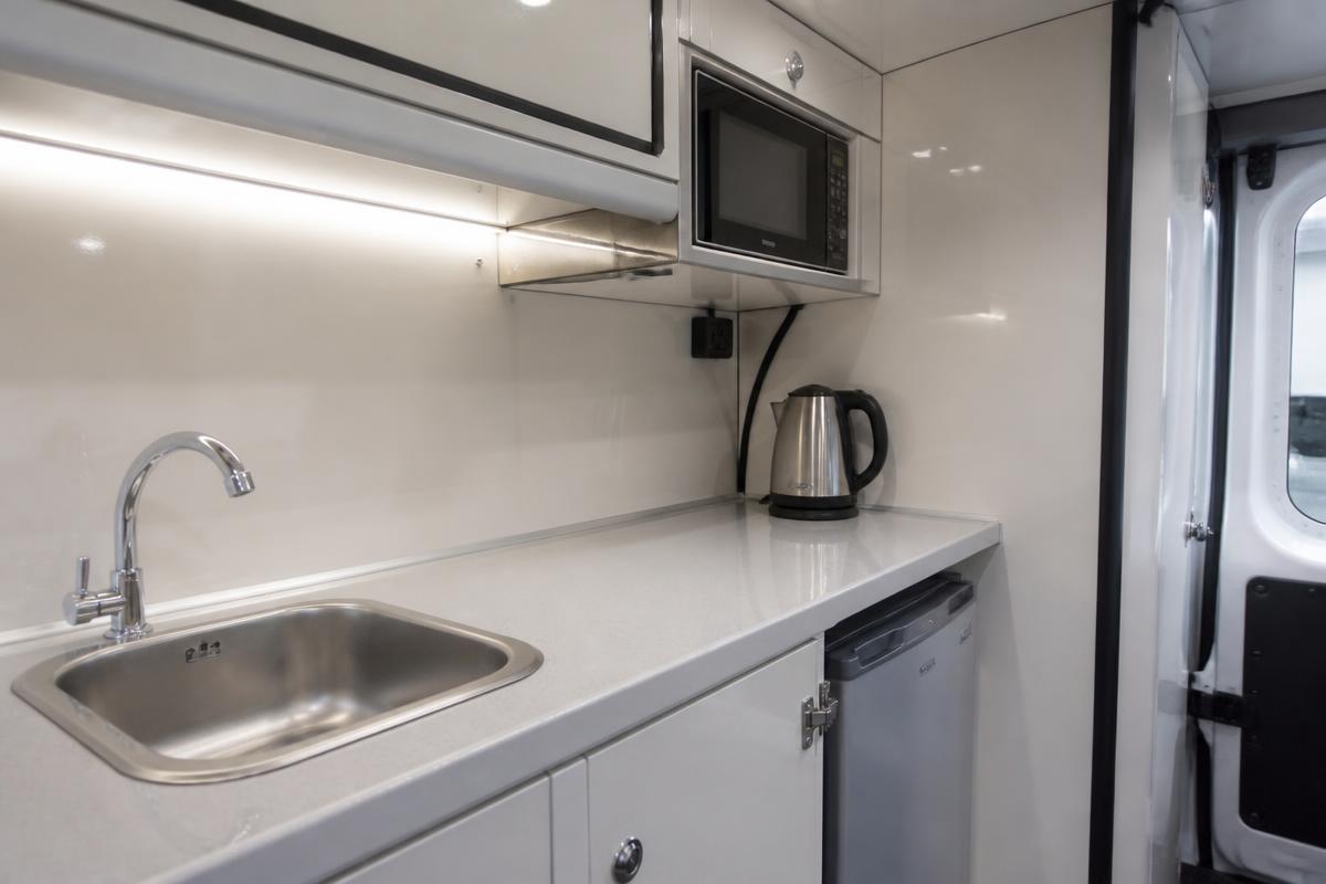 Welfare van kitchen worktop with sink, kettle and microwave