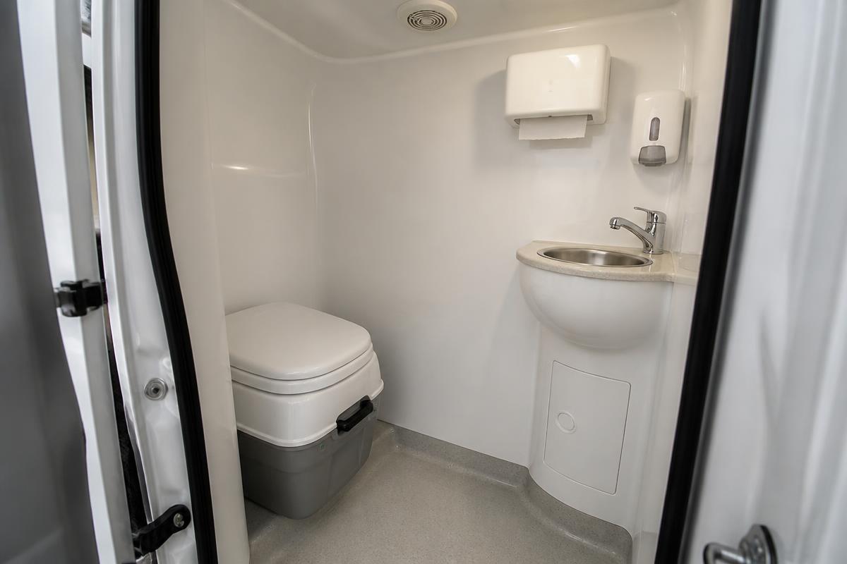 Welfare van toilet cubicle with hand wash basin
